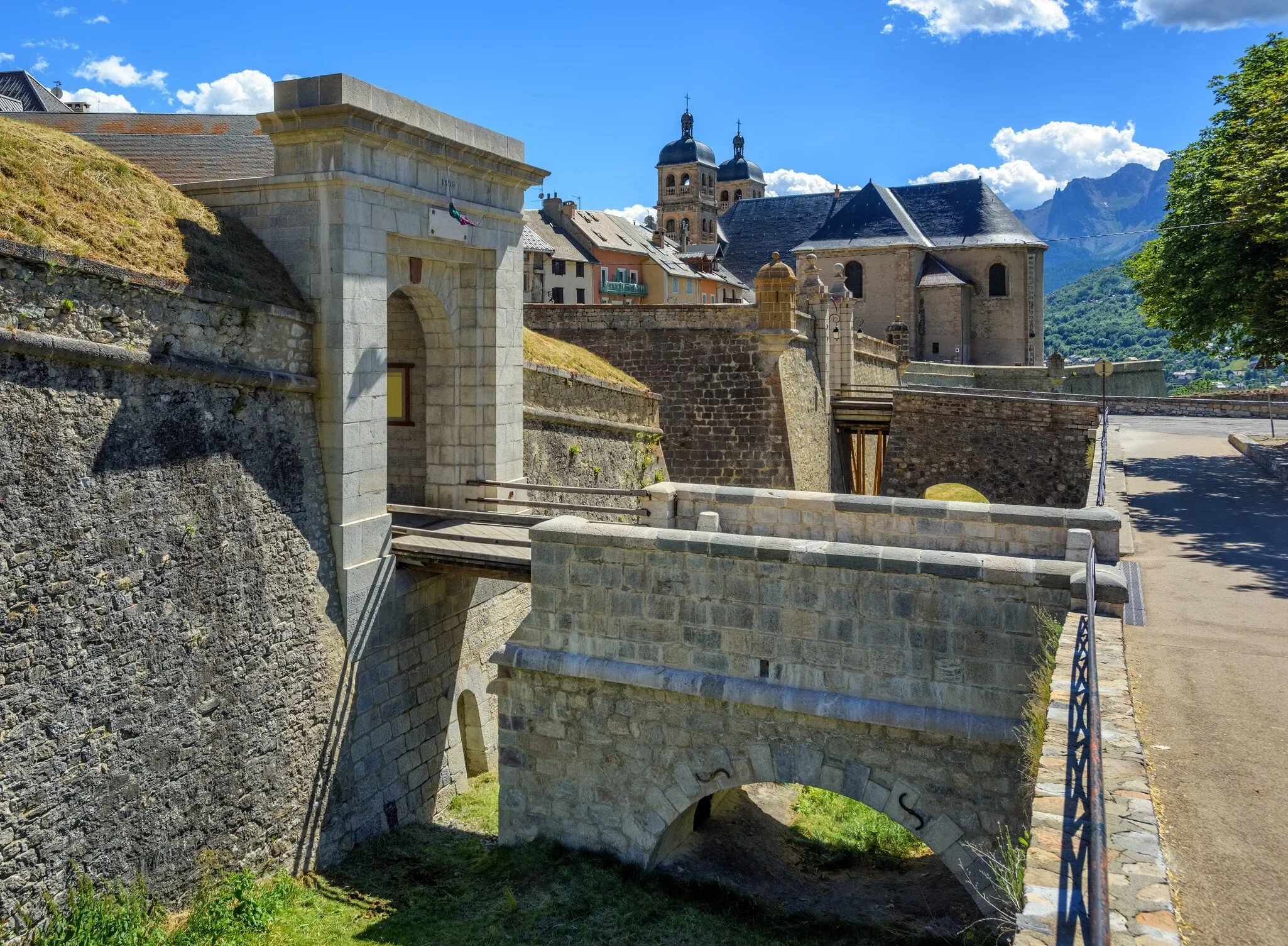 Stone archway and historic buildings inside Briançon’s fortified old town