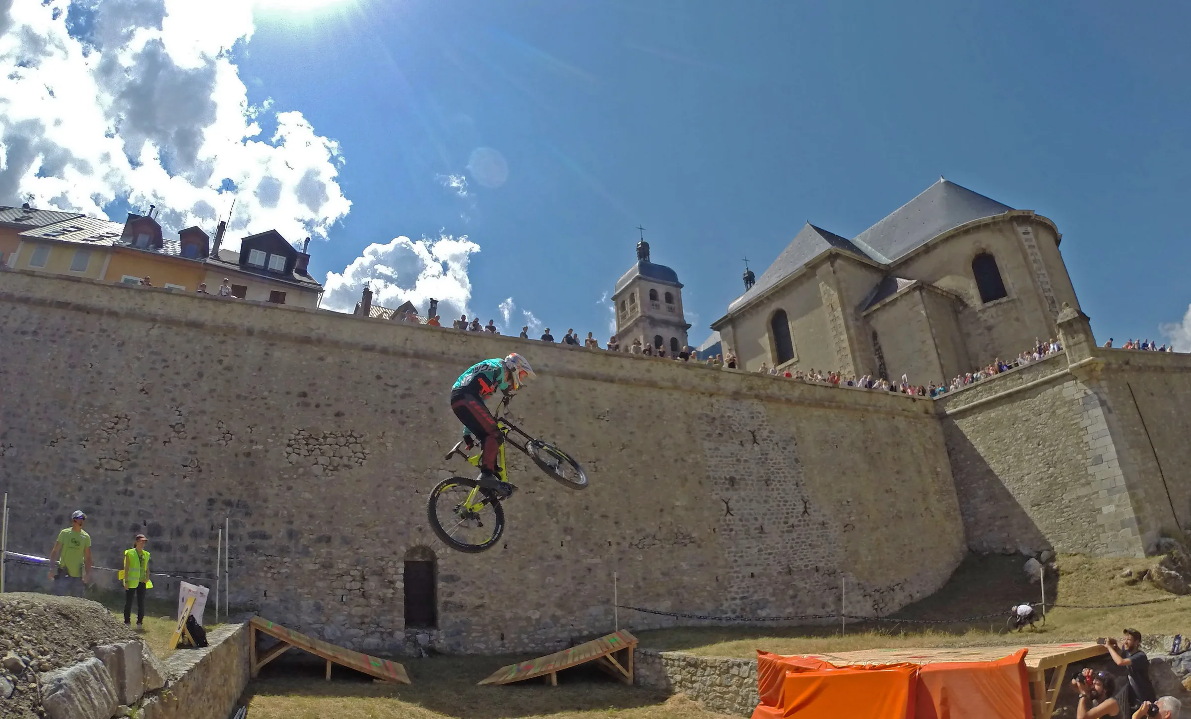 Mountain biker jumping alongside Briançon’s historic stone fortifications