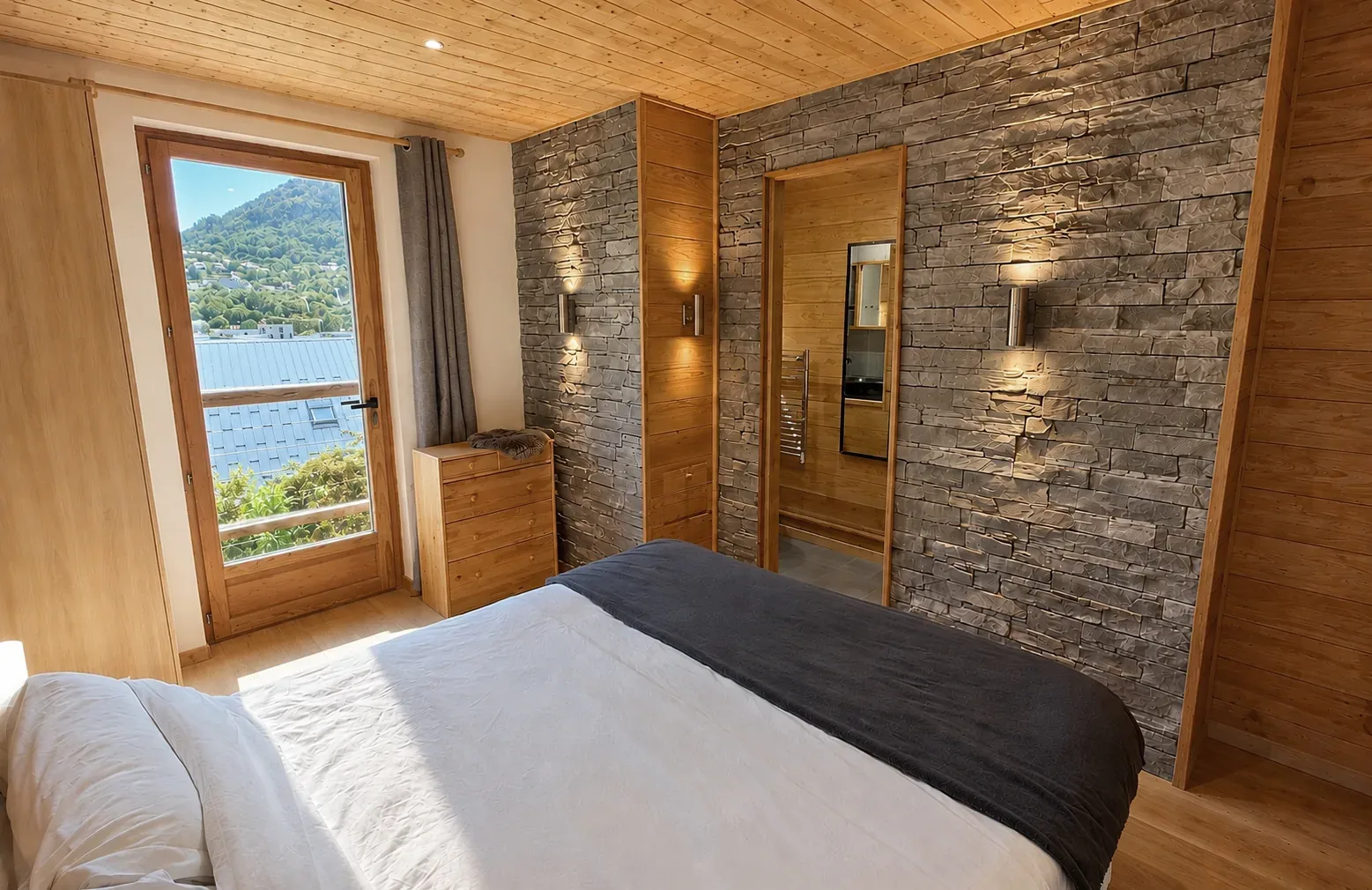 Chalet bedroom with a timber ceiling, stone wall and balcony door